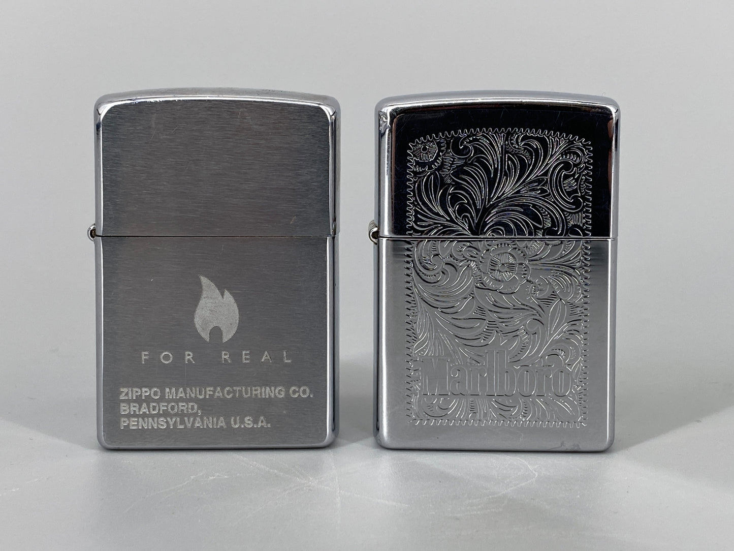 2 Zippo Benzinfeuerzeuge, "Marlboro" und "For Real"